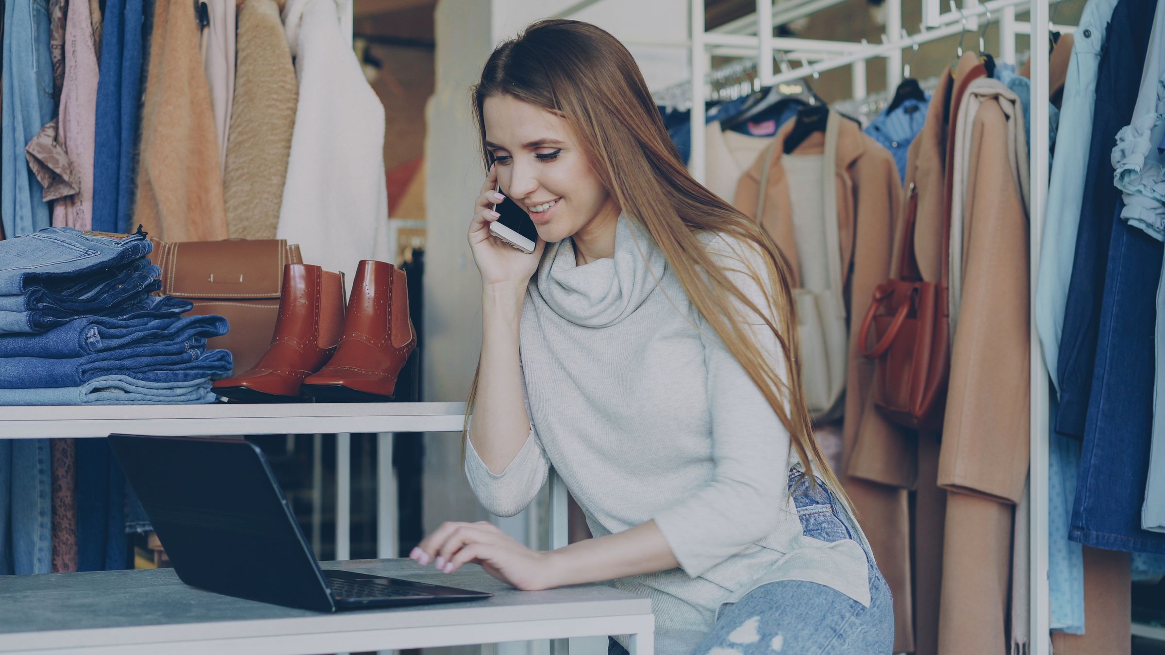Online store owner running her shop on autopilot from a laptop