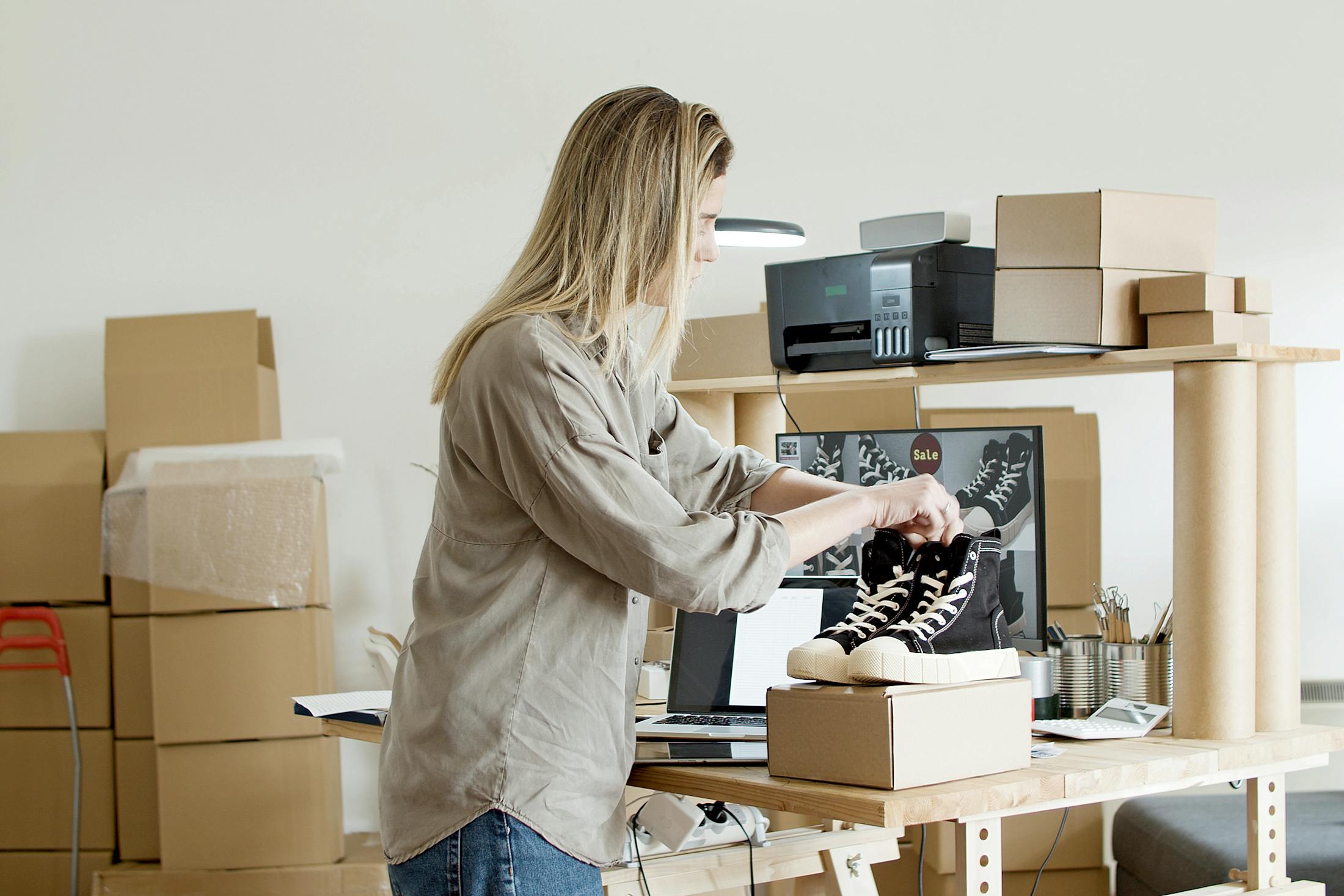 Ecommerce store owner packing an order at her workspace