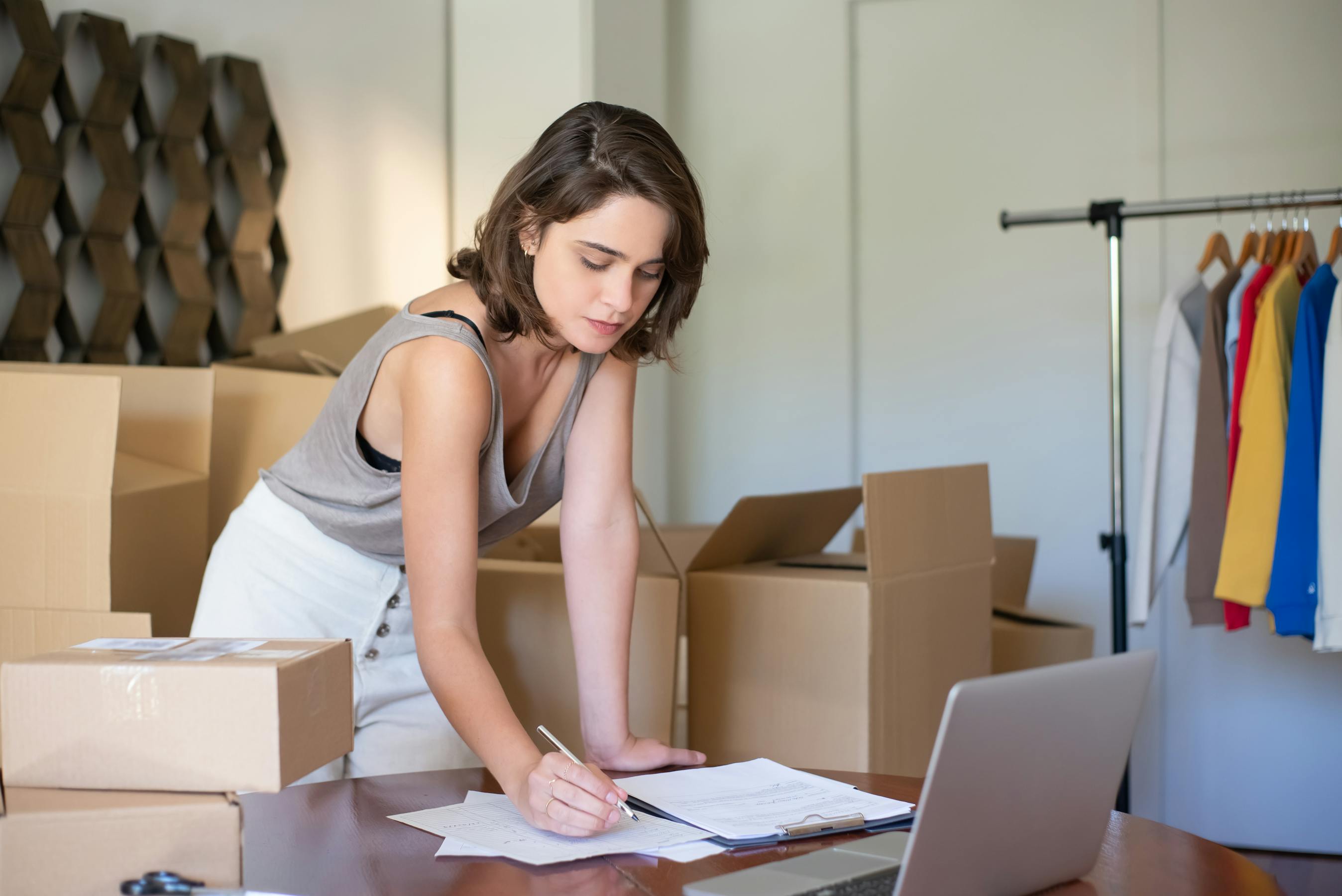 A store owner managing online orders from her workspace